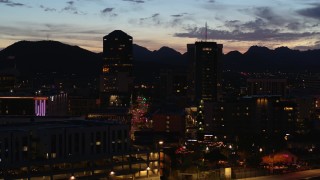 DX0002_147_038 - 5.7K aerial stock footage a reverse view of two towering office buildings at twilight, Downtown Tucson, Arizona
