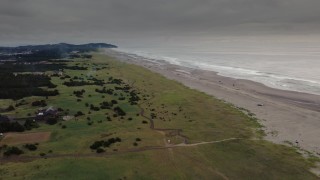 DX0002_148_018 - 4K aerial stock footage of flying toward people on the beach in Long Beach, Washington