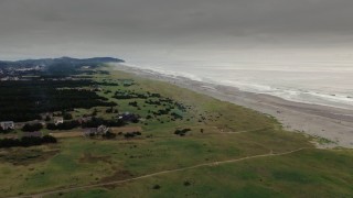DX0002_148_027 - 4K aerial stock footage a wide view of beach and ocean waves at sunset in Long Beach, Washington