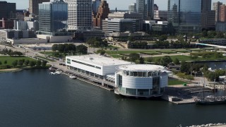 DX0002_149_011 - 5.7K aerial stock footage of descending near Discovery World museum in Downtown Milwaukee, Wisconsin