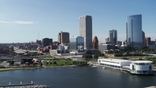 DX0002_149_023 - 5.7K aerial stock footage flying by the waterfront museum with a view of city buildings in Downtown Milwaukee, Wisconsin