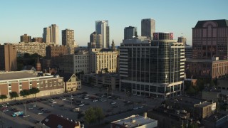 DX0002_150_011 - 5.7K stock footage aerial video of flying away from a dormitory complex at sunset in Downtown Milwaukee, Wisconsin