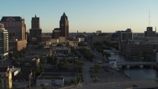 DX0002_150_025 - 5.7K aerial stock footage tall office tower by the Milwaukee River at sunset, Downtown Milwaukee, Wisconsin