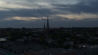 DX0002_150_034 - 5.7K aerial stock footage of church steeples at twilight, Milwaukee, Wisconsin