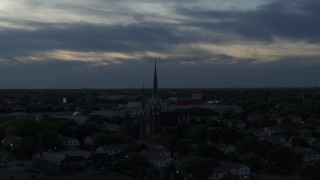 DX0002_150_035 - 5.7K aerial stock footage of a view of church steeples at twilight, Milwaukee, Wisconsin