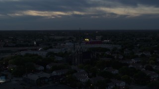 DX0002_150_036 - 5.7K aerial stock footage of ascending away from church steeples at twilight, Milwaukee, Wisconsin