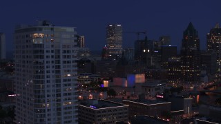 DX0002_151_003 - 5.7K aerial stock footage of skyscrapers, office tower, reveal apartment tower at night, Downtown Milwaukee, Wisconsin