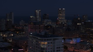 DX0002_151_007 - 5.7K aerial stock footage of skyscrapers at night, seen while passing The Moderne, Downtown Milwaukee, Wisconsin