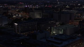 DX0002_151_011 - 5.7K aerial stock footage of flying away from the Milwaukee County Circuit Court at night, Milwaukee, Wisconsin
