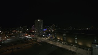 DX0002_151_012 - 5.7K aerial stock footage of a high-rise apartment building at night, Downtown Milwaukee, Wisconsin