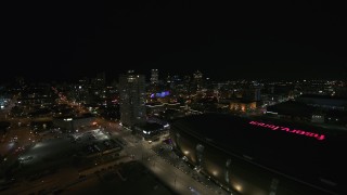 DX0002_151_015 - 5.7K aerial stock footage approach high-rise apartment building and city skyline at night, Downtown Milwaukee, Wisconsin