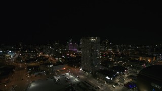 DX0002_151_021 - 5.7K aerial stock footage passing an apartment high-rise at night, Downtown Milwaukee, Wisconsin