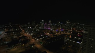 DX0002_151_022 - 5.7K aerial stock footage fly away from the city's skyline, reveal apartment high-rise at night, Downtown Milwaukee, Wisconsin