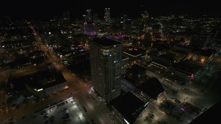 DX0002_151_023 - 5.7K aerial stock footage approach and orbit an apartment high-rise at night, Downtown Milwaukee, Wisconsin