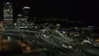 DX0002_151_034 - 5.7K aerial stock footage of light traffic on I-794 freeway interchange at night, Downtown Milwaukee, Wisconsin