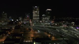 DX0002_151_036 - 5.7K aerial stock footage of US Bank Center skyscraper by I-794 at night, Downtown Milwaukee, Wisconsin