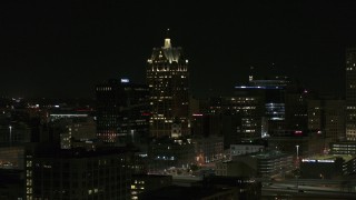 DX0002_151_039 - 5.7K aerial stock footage wide orbit of a skyscraper in Downtown Milwaukee, Wisconsin at night