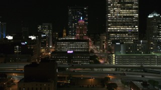 DX0002_151_040 - 5.7K aerial stock footage of the Wisconsin Gas Building in Downtown Milwaukee, Wisconsin at night