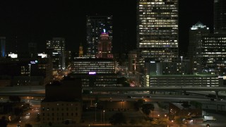 DX0002_151_041 - 5.7K aerial stock footage of flying by the Wisconsin Gas Building in Downtown Milwaukee, Wisconsin at night