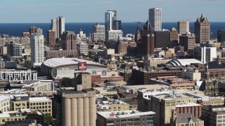 DX0002_152_014 - 5.7K aerial stock footage wide view of the city's skyline in Downtown Milwaukee, Wisconsin, seen from industrial buildings