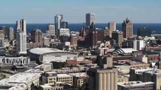 DX0002_152_015 - 5.7K aerial stock footage wide view of the city's skyline, arena in Downtown Milwaukee, Wisconsin, seen from industrial buildings