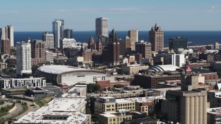 DX0002_152_017 - 5.7K aerial stock footage of the city's skyline in Downtown Milwaukee, Wisconsin, ascend near industrial buildings