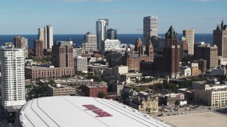 DX0002_152_034 - 5.7K aerial stock footage fly away fromthe city's skyline and arena in Downtown Milwaukee, Wisconsin