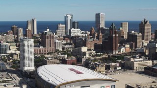 DX0002_152_035 - 5.7K aerial stock footage reverse view of the city's skyline and arena in Downtown Milwaukee, Wisconsin
