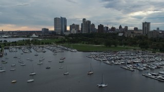 DX0002_154_043 - 5.7K aerial stock footage of Veterans Park and skyline of Downtown Milwaukee, Wisconsin while descending by marina