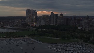 DX0002_155_033 - 5.7K aerial stock footage flyby and away from the city's skyline at twilight, Downtown Milwaukee, Wisconsin