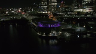 DX0002_157_009 - 5.7K aerial stock footage orbiting Discovery World museum at night, Downtown Milwaukee, Wisconsin
