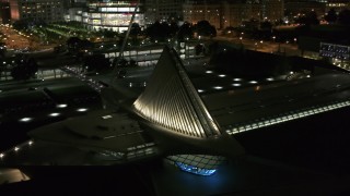 DX0002_157_018 - 5.7K aerial stock footage orbit and fly away from the lakefront museum at night, Downtown Milwaukee, Wisconsin