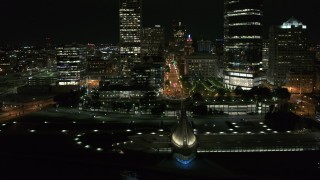 DX0002_157_022 - 5.7K aerial stock footage ascend over museum for view of Wisconsin Ave at night, Downtown Milwaukee, Wisconsin