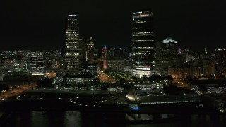 DX0002_157_024 - 5.7K aerial stock footage stationary view of the lakefront museum and skyscrapers at night, Downtown Milwaukee, Wisconsin