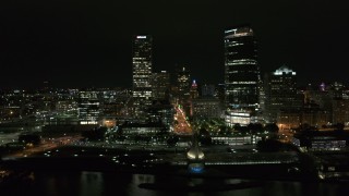 DX0002_157_026 - 5.7K aerial stock footage of two skyscrapers and lakefront museum at night, Downtown Milwaukee, Wisconsin