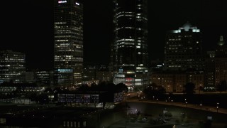 DX0002_157_035 - 5.7K aerial stock footage orbit base of a towering skyscraper at night, Downtown Milwaukee, Wisconsin