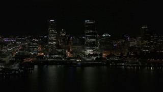DX0002_157_041 - 5.7K aerial stock footage view of towering skyscrapers seen from the lake at night, Downtown Milwaukee, Wisconsin
