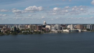 DX0002_158_005 - 5.7K aerial stock footage slowly fly away from lakefront city buildings in Madison, Wisconsin