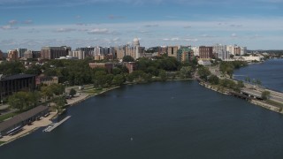 DX0002_158_014 - 5.7K aerial stock footage descend toward lake with view of of apartment buildings near the capitol dome in Madison, Wisconsin