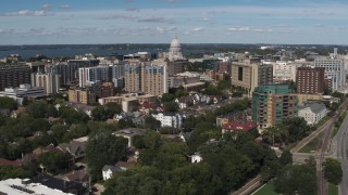 DX0002_158_016 - 5.7K aerial stock footage descend with view of of apartment complexes near the capitol dome in Madison, Wisconsin