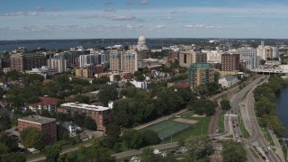 DX0002_158_017 - 5.7K aerial stock footage reverse view of apartment complexes near the capitol dome in Madison, Wisconsin