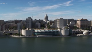 DX0002_158_026 - 5.7K aerial stock footage reverse view of capitol dome, office buildings, and convention center, Madison, Wisconsin