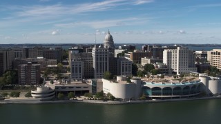 DX0002_158_032 - 5.7K aerial stock footage flyby the convention center with view of capitol dome, office buildings, Madison, Wisconsin