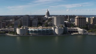 DX0002_158_035 - 5.7K aerial stock footage of the capitol dome and office buildings, seen while passing convention center, Madison, Wisconsin