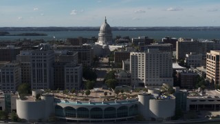 DX0002_160_001 - 5.7K aerial stock footage of the capitol dome seen while ascending past office buildings, Madison, Wisconsin