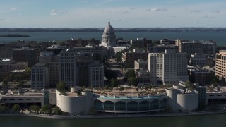 DX0002_160_003 - 5.7K aerial stock footage of the capitol seen while passing by office buildings and convention center, Madison, Wisconsin