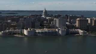 DX0002_160_009 - 5.7K aerial stock footage ascending away from convention center with capitol and office buildings in background, Madison, Wisconsin