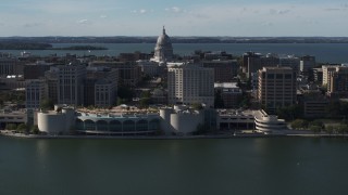 DX0002_160_010 - 5.7K aerial stock footage of passing the convention center with capitol and office buildings in background, Madison, Wisconsin