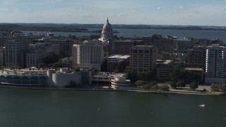 DX0002_160_011 - 5.7K aerial stock footage of a reverse view of the convention center with capitol and office buildings in background, Madison, Wisconsin