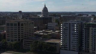 DX0002_160_015 - 5.7K aerial stock footage focus on capitol and pass by office buildings, Madison, Wisconsin